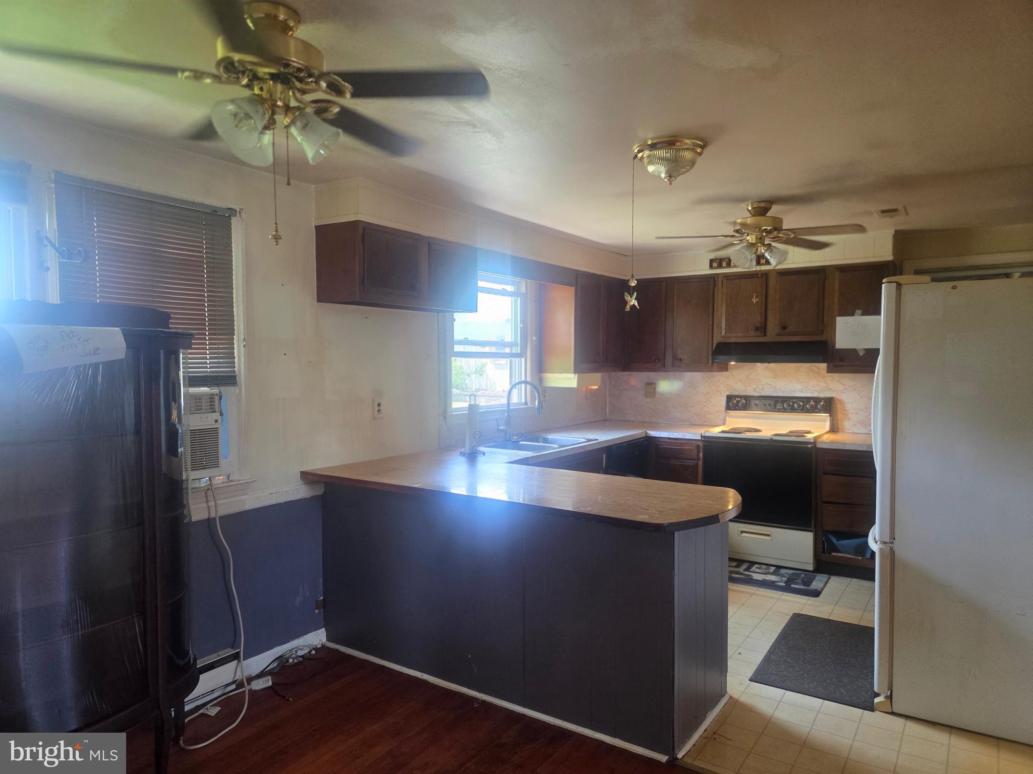 5880 Cardinal Street Mount Jackson, VA 22842 - Photo 21 of 44 a kitchen with kitchen island a counter space a sink appliances and cabinets
