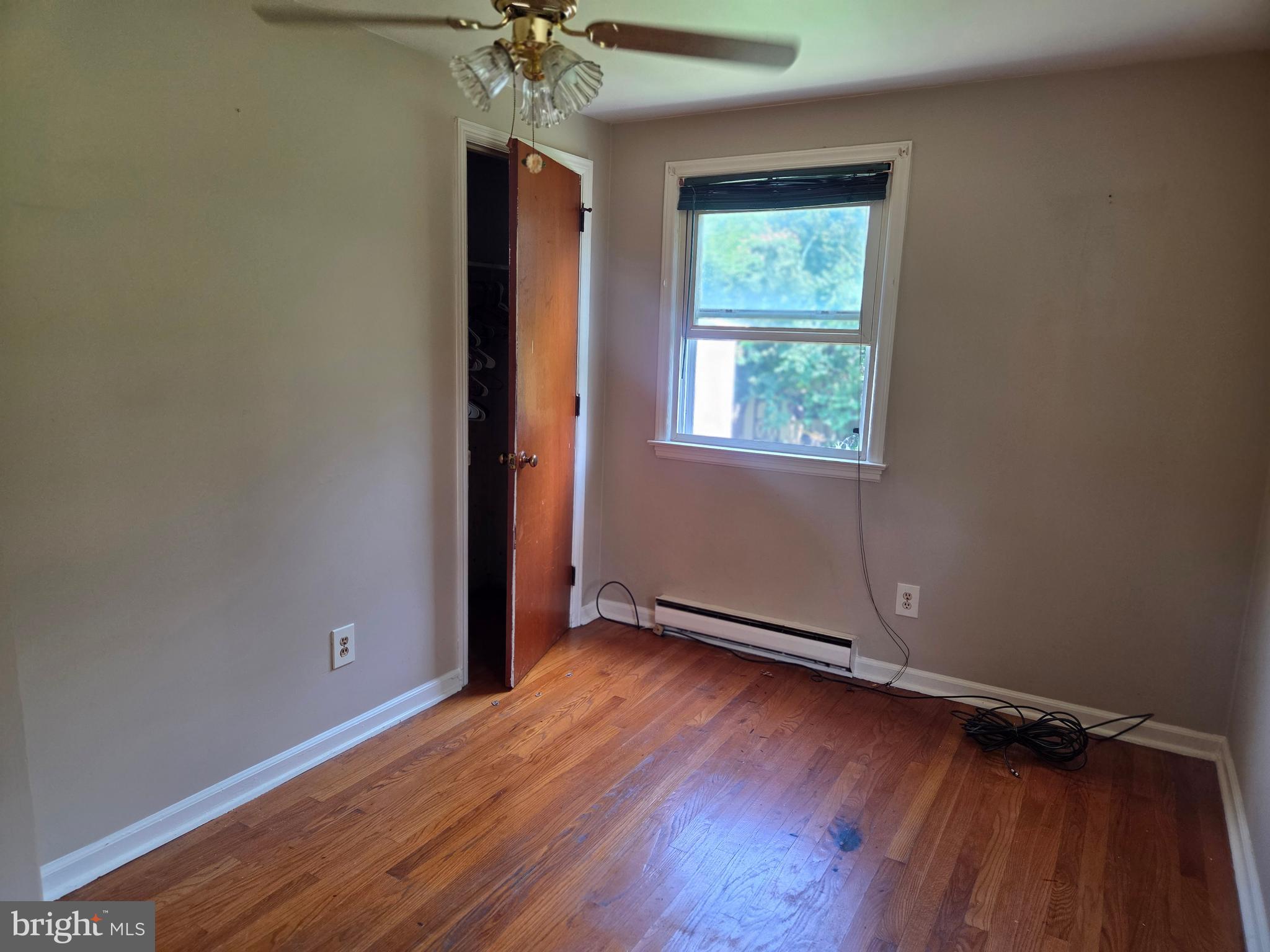 5880 Cardinal Street Mount Jackson, VA 22842 - Photo 29 of 44 an empty room with wooden floor chandelier and windows