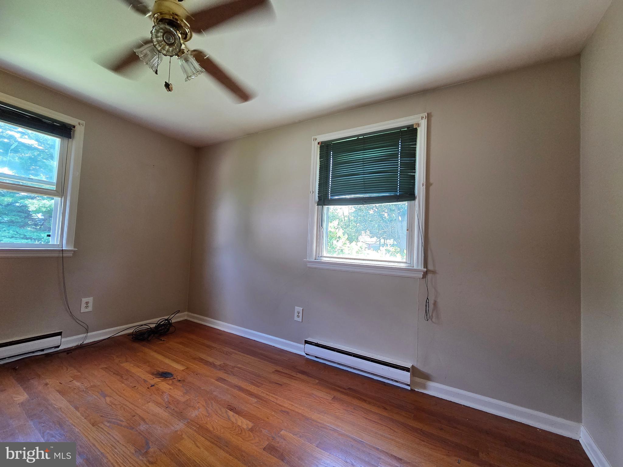 5880 Cardinal Street Mount Jackson, VA 22842 - Photo 38 of 44 an empty room with wooden floor chandelier fan and windows