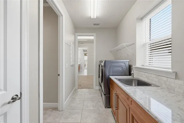 a bedroom with furniture and large windows