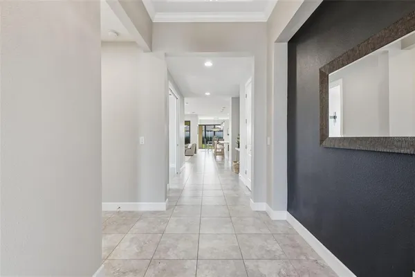a living room with furniture and large windows