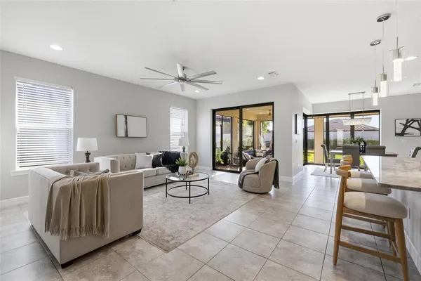 a living room with stainless steel appliances furniture and a large window