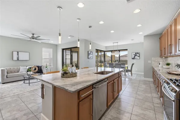 a kitchen with granite countertop a stove and a microwave