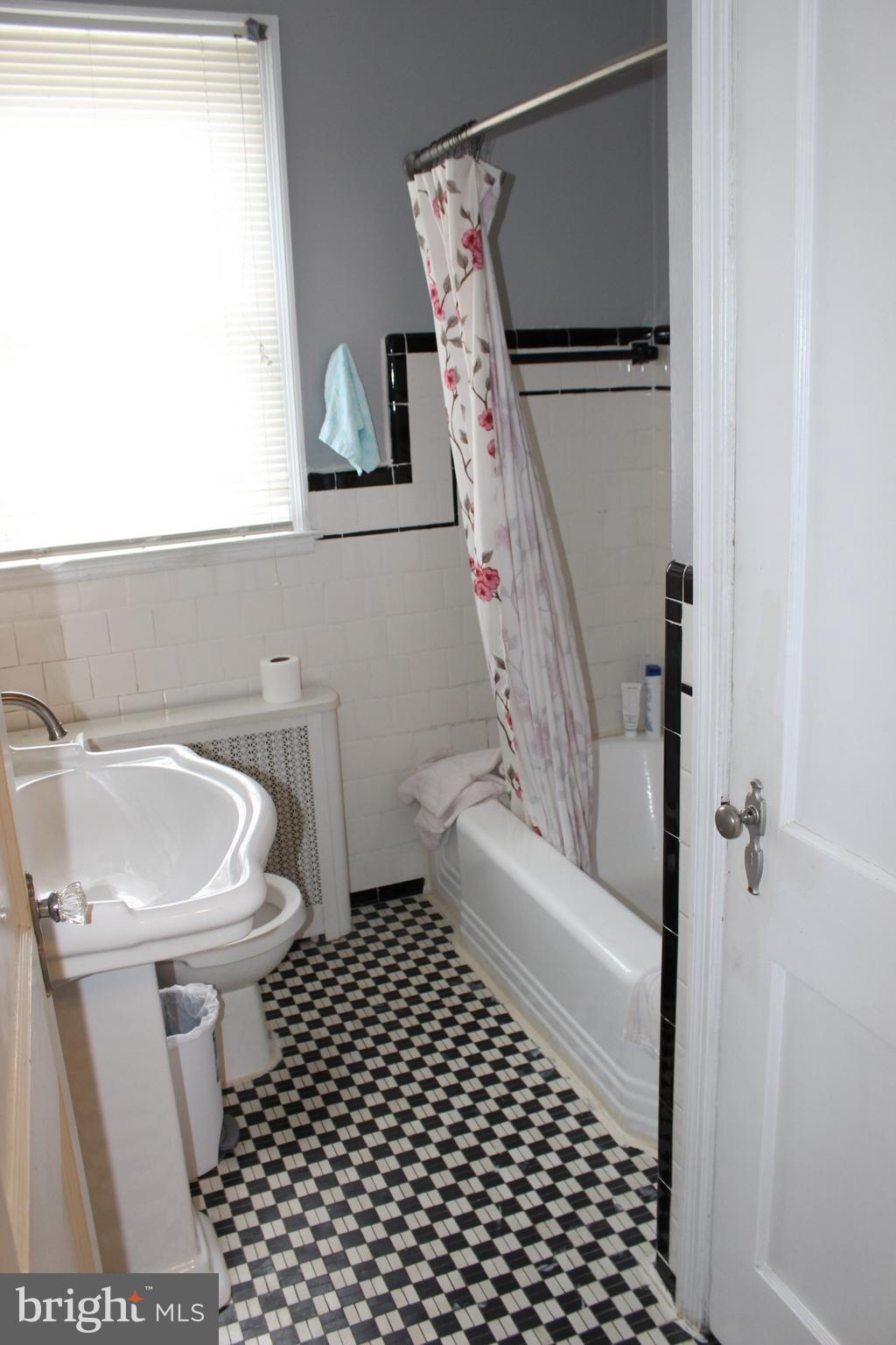 214 Mt De Sales Road Baltimore, MD 21229 - Photo 13 of 29 a bathroom with a sink toilet and shower