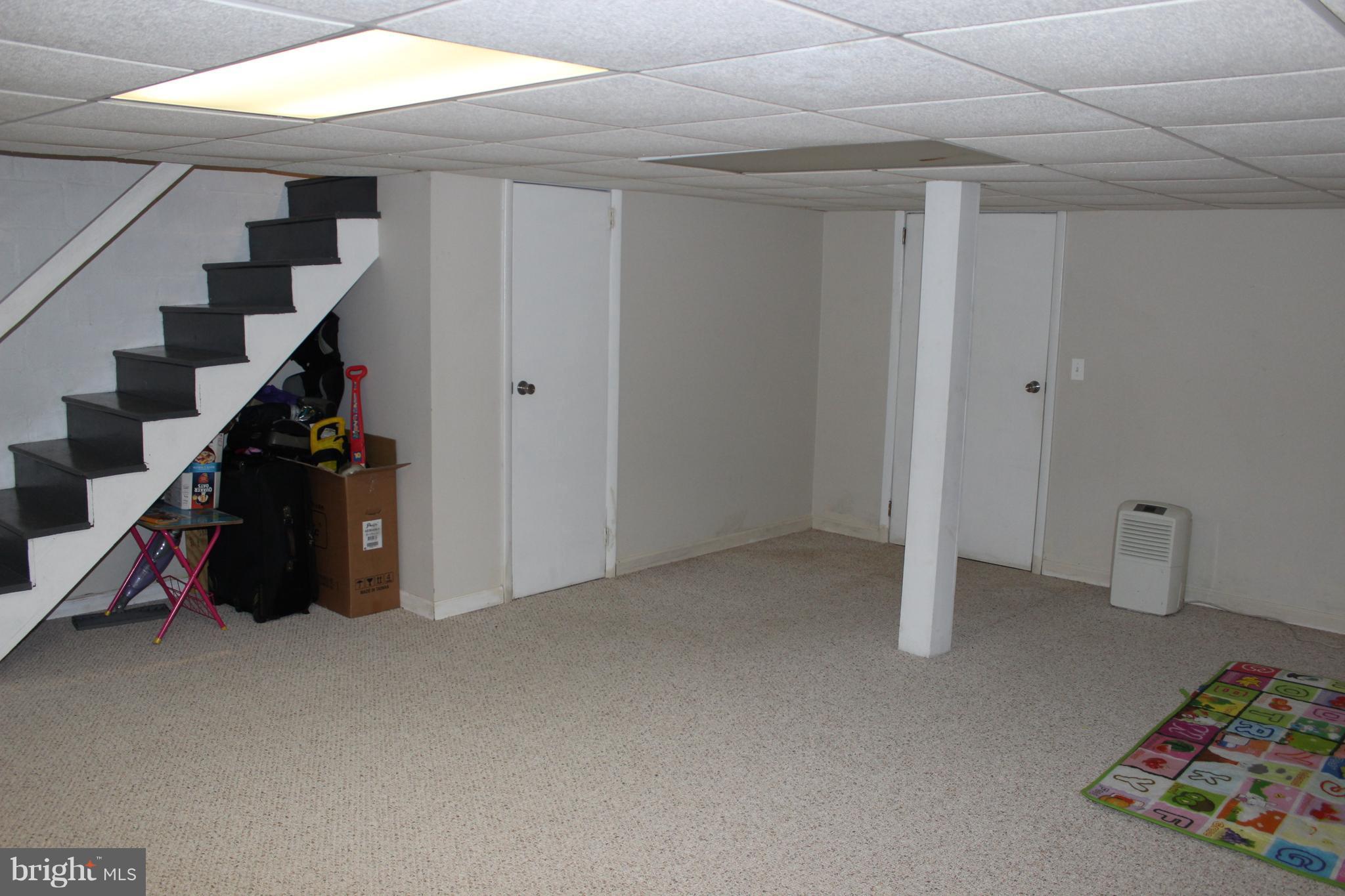 214 Mt De Sales Road Baltimore, MD 21229 - Photo 23 of 29 a view of an empty room with stairs and toys
