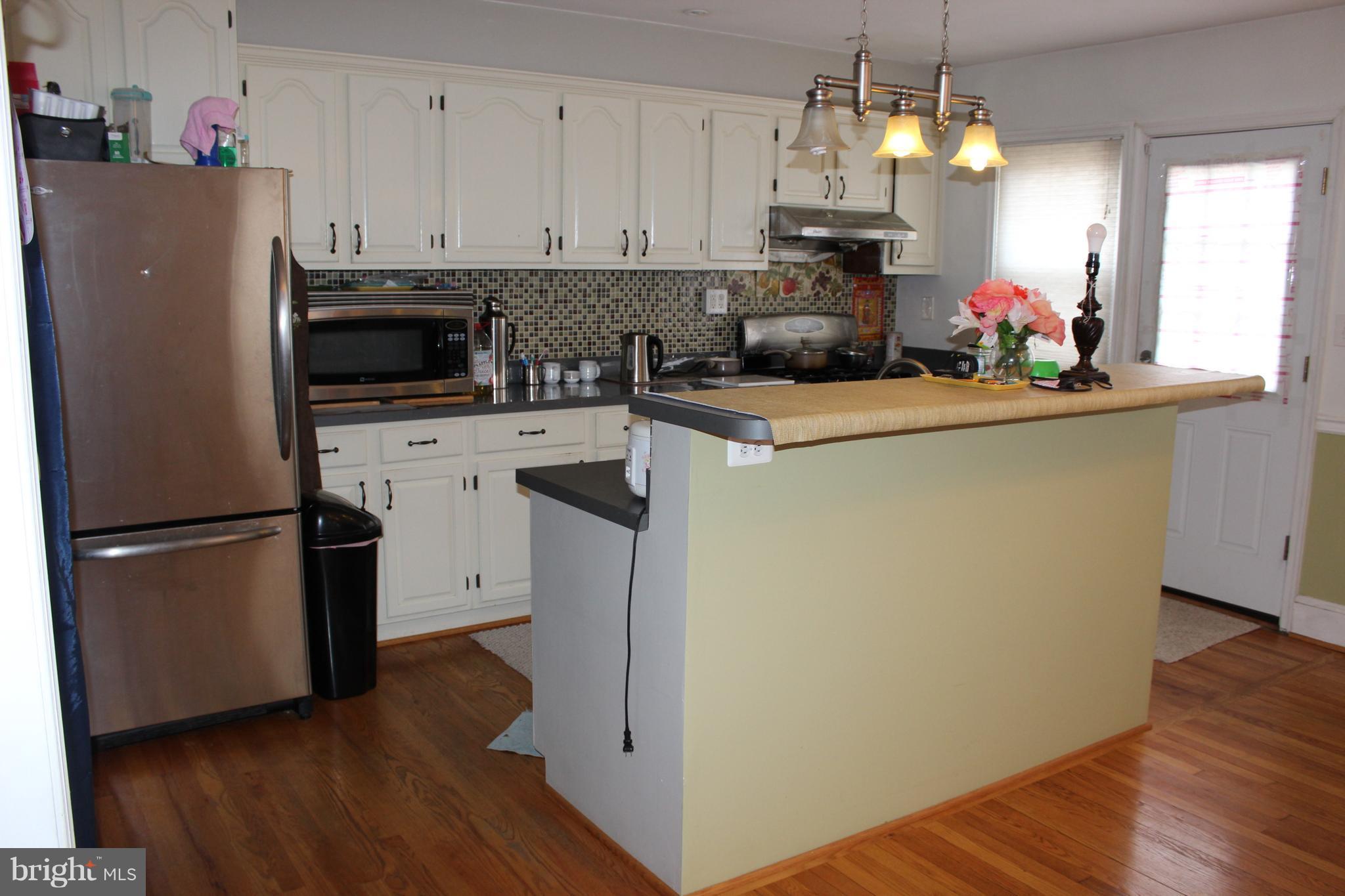 214 Mt De Sales Road Baltimore, MD 21229 - Photo 7 of 29 a kitchen with refrigerator and cabinets