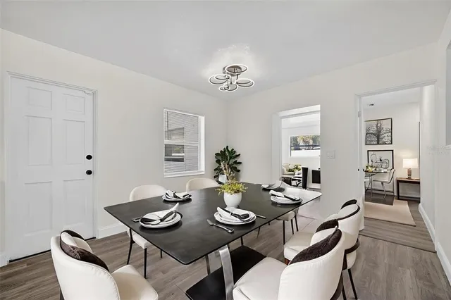 a view of a big room with wooden floor and windows