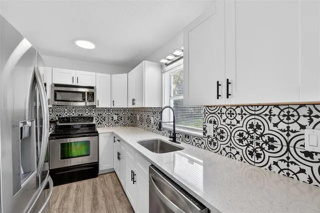 a bedroom with a large bed and a flat screen tv