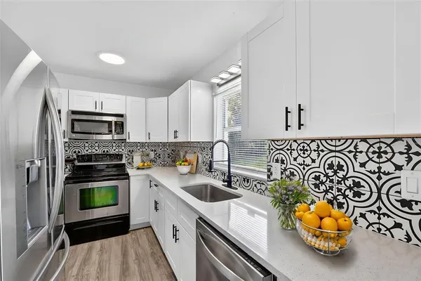 a bedroom with a large bed and a potted plant