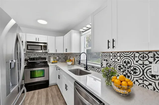 a bedroom with a large bed and a potted plant