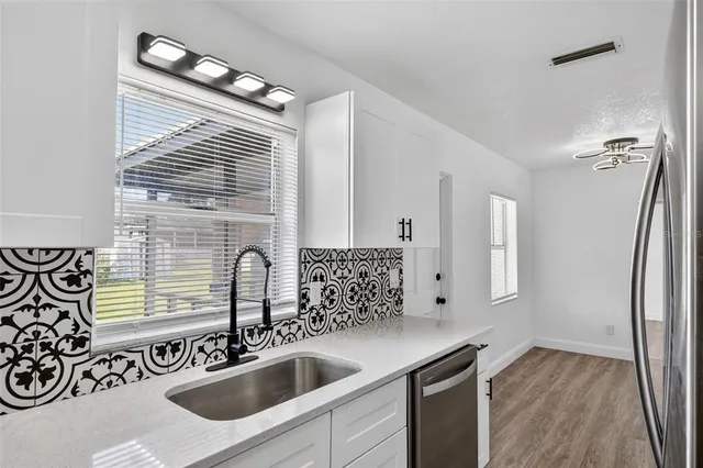 a bedroom with a bed and a potted plant