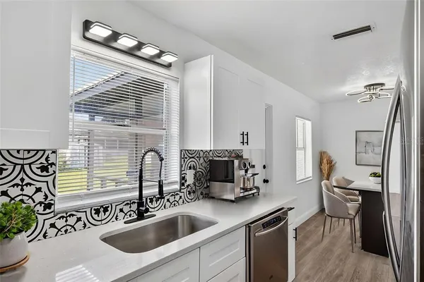 a view of an empty room and wooden floor