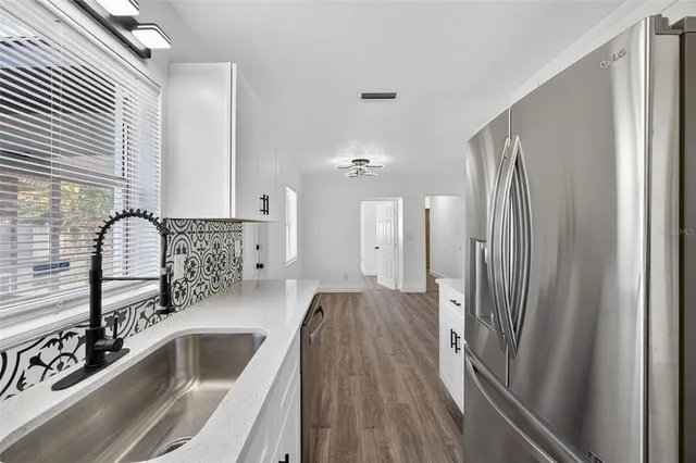 a bedroom with a bed potted plant and a dresser