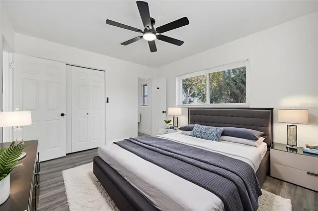 a view of a house with a yard and a large tree
