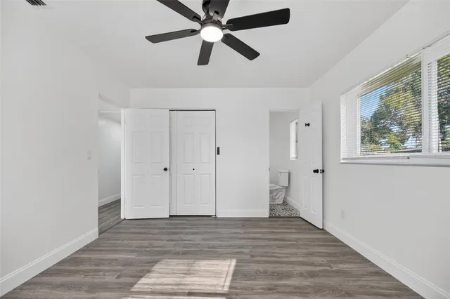 a front view of a house with a yard and potted plants