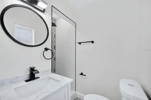 an aerial view of residential houses with outdoor space and swimming pool