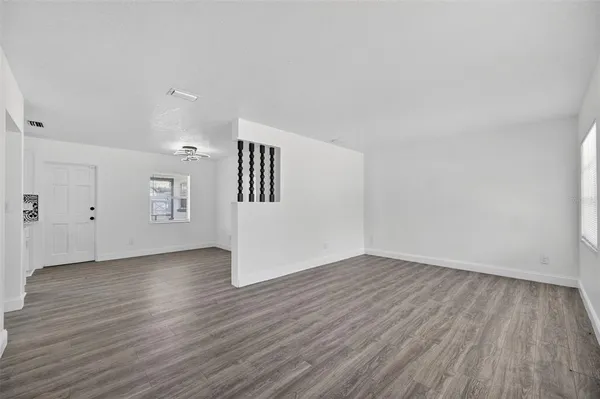a living room with furniture wooden floor and a flat screen tv