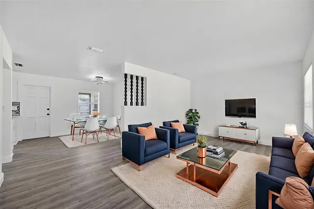 a view of a room with wooden floor and ceiling fan
