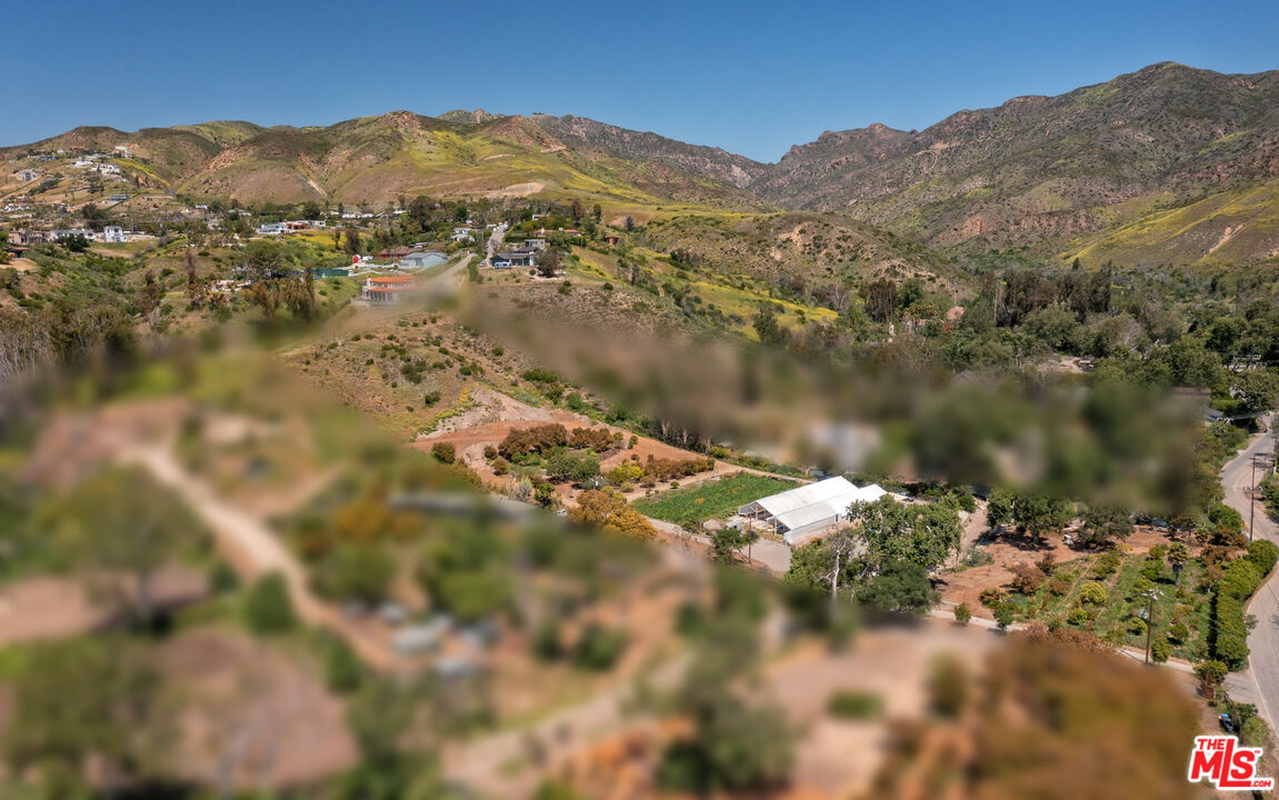 5949 Bonsall Drive Malibu, CA 90265 - Photo 7 of 14 a view of a lake with mountains in the background