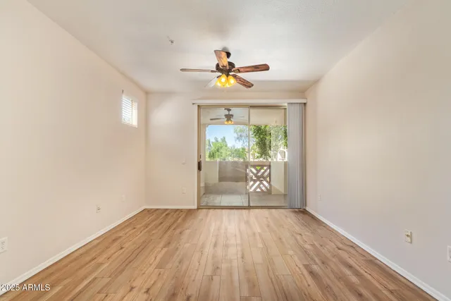 a view of a room with wooden floor and a window