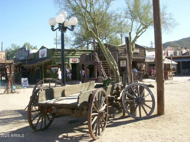 a view of a patio with a table and chairs under an umbrella
