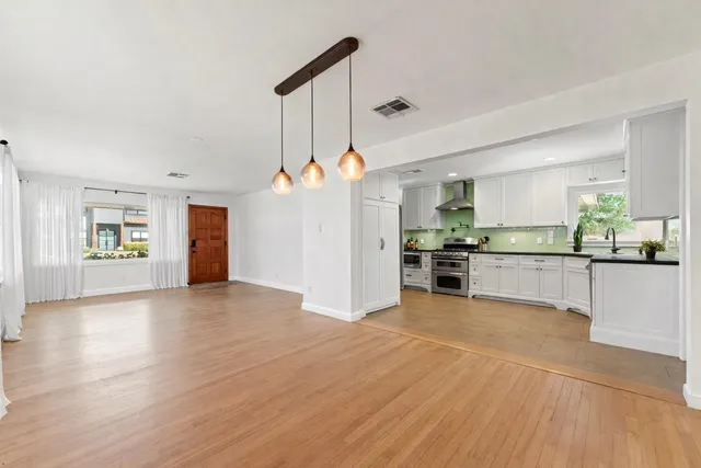 a view of a kitchen with a sink and a stove top oven