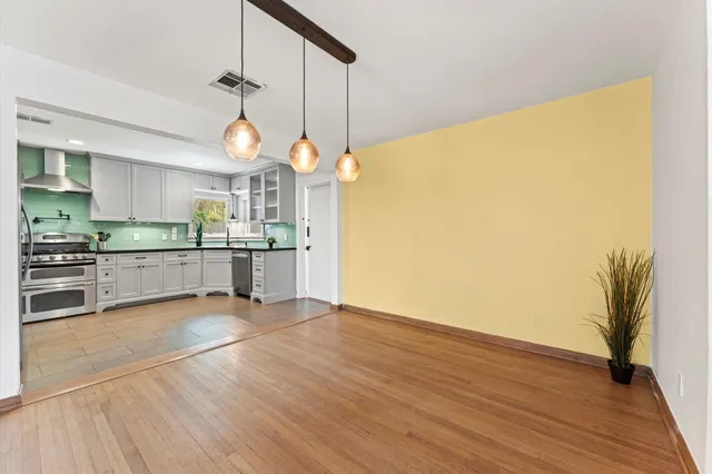 a view of a kitchen with wooden floor