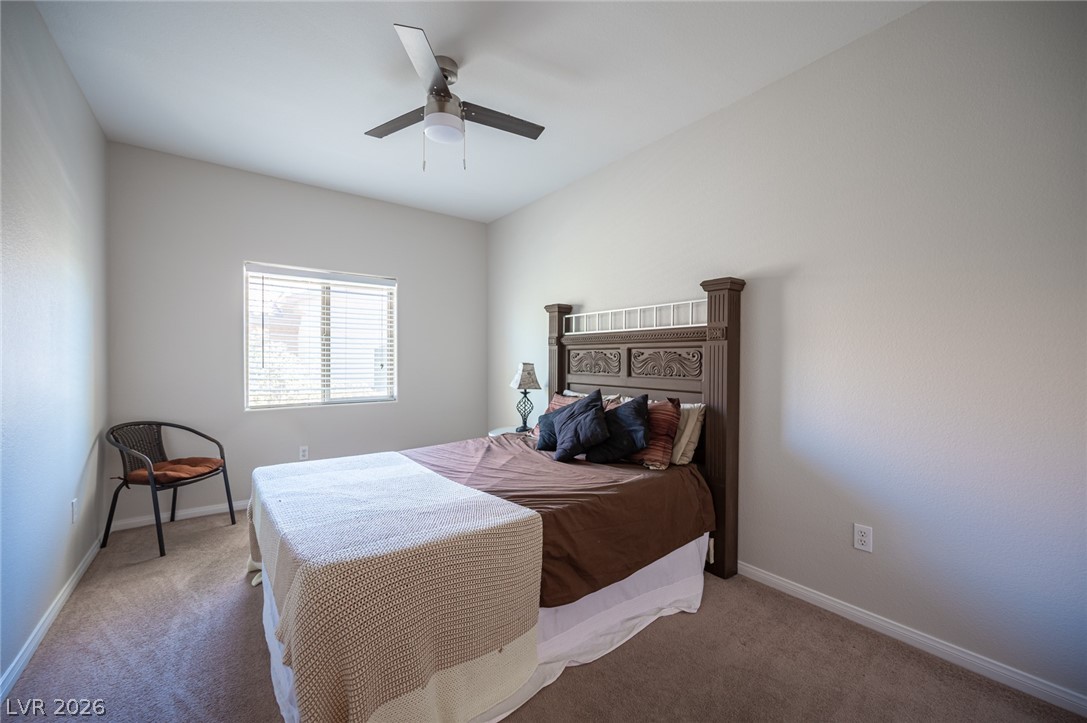 7701 West Robindale Road, Unit 274 Las Vegas, NV 89113 - Photo 25 of 38 This serene bedroom offers a comfortable retreat with soft carpet and natural light.