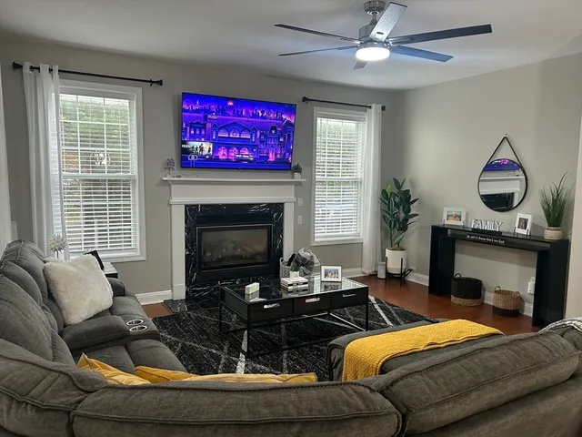 a living room with furniture and a fireplace