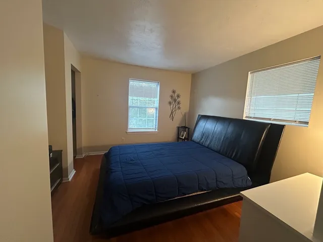 a bedroom with a bed and window