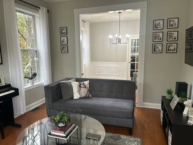 a living room with furniture and wooden floor