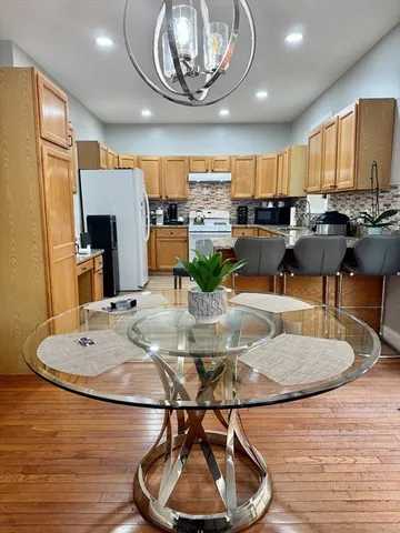 a kitchen with a table chairs and a kitchen view