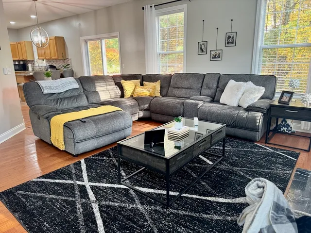 a living room with furniture and wooden floor