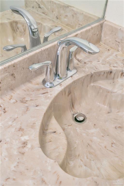 240 East Dicker Road Pharr, TX 78577 - Photo 12 of 23 Integral vanity sink with a light-toned, variegated finish and polished chrome faucet