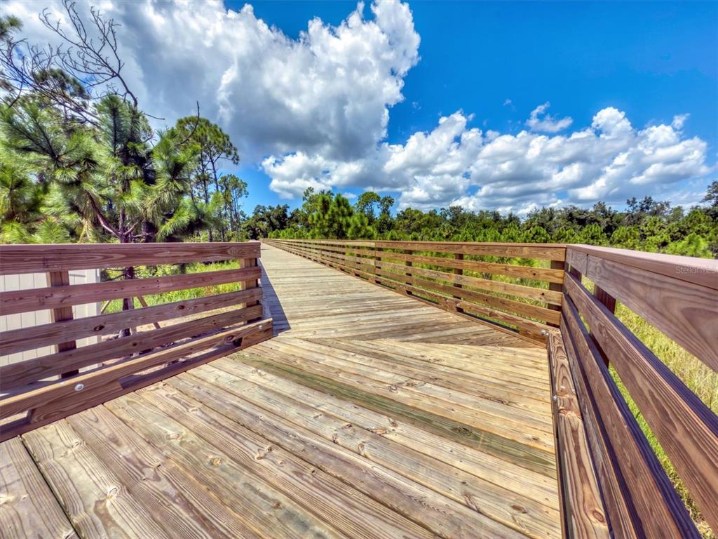 9001 Gasparilla Road, Unit 87 Placida, FL 33947 - Photo 70 of 75 a view of a balcony with wooden floor and city view