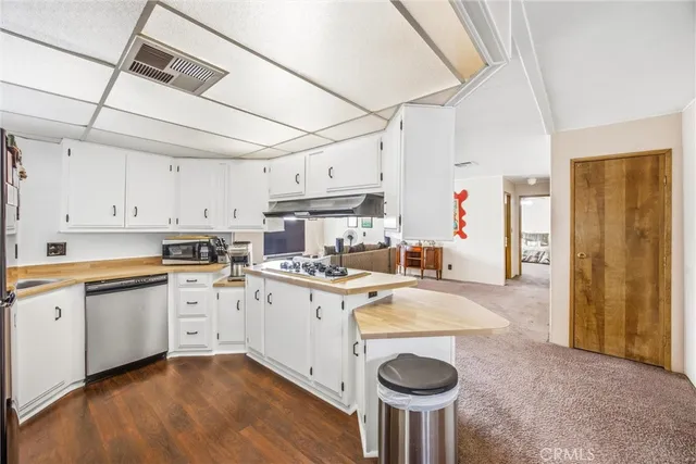 a kitchen with kitchen island a stove a sink and a refrigerator