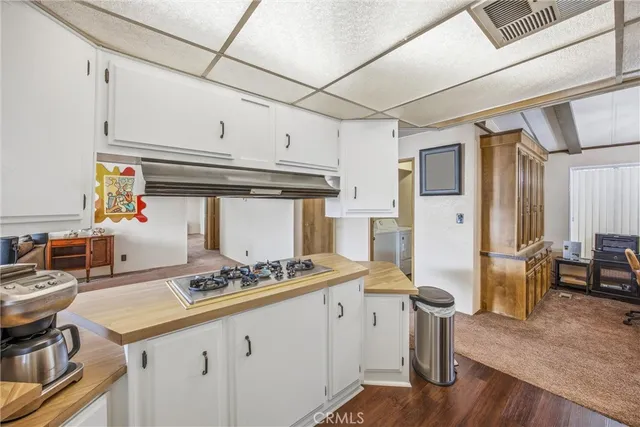 a kitchen with stainless steel appliances granite countertop a sink stove and wooden cabinets