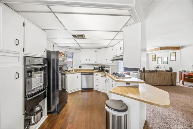a kitchen with refrigerator and cabinets