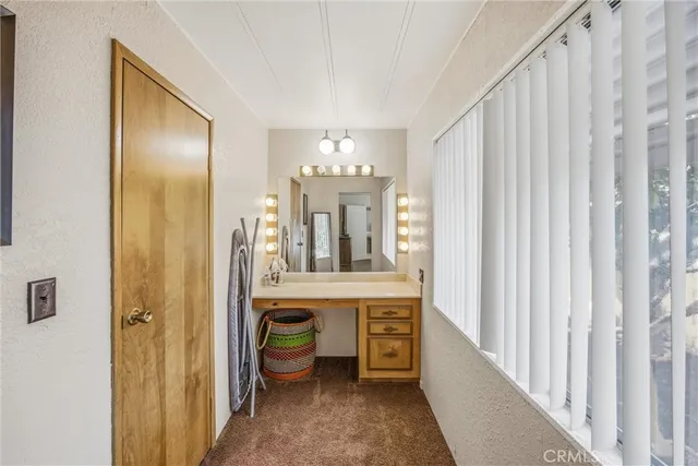 a view of a hallway with chandelier and living room