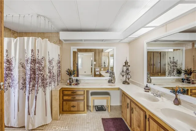 a bathroom with a double vanity sink mirror and