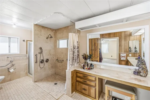 a bathroom with a shower sink and mirror