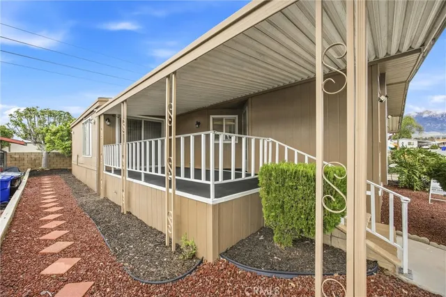 a view of a house with a small yard and wooden fence