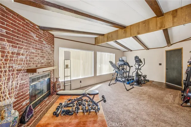 a living room with furniture a fireplace and next to a window