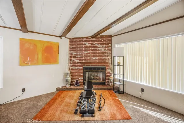 a living room with fireplace furniture and a large window
