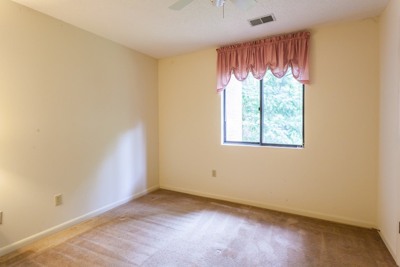 113 Turtle Creek Road, Unit 7 Charlottesville, VA 22901 - Photo 19 of 32 an empty room with wooden floor and windows