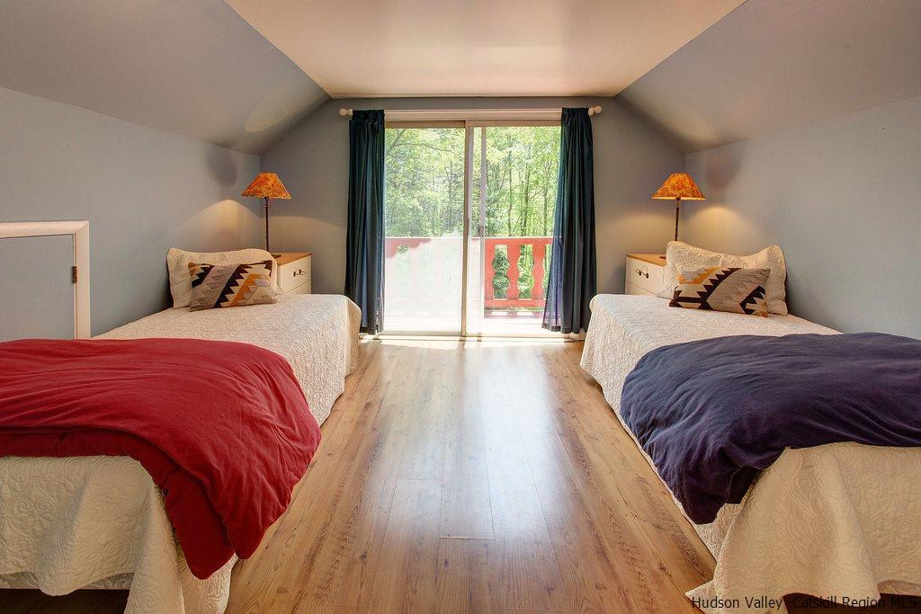 705 Henry Williams Road Roxbury, NY 12474 - Photo 19 of 34 a bedroom with a bed and wooden floor