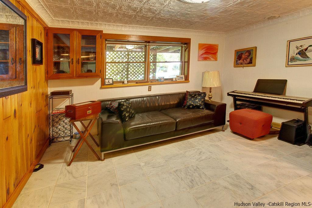 705 Henry Williams Road Roxbury, NY 12474 - Photo 10 of 34 a living room with furniture a flat screen tv and a window