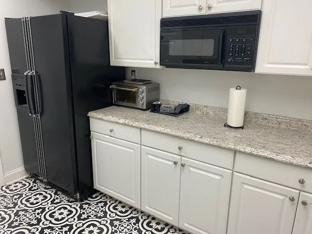 a kitchen with stainless steel appliances granite countertop a refrigerator and a stove