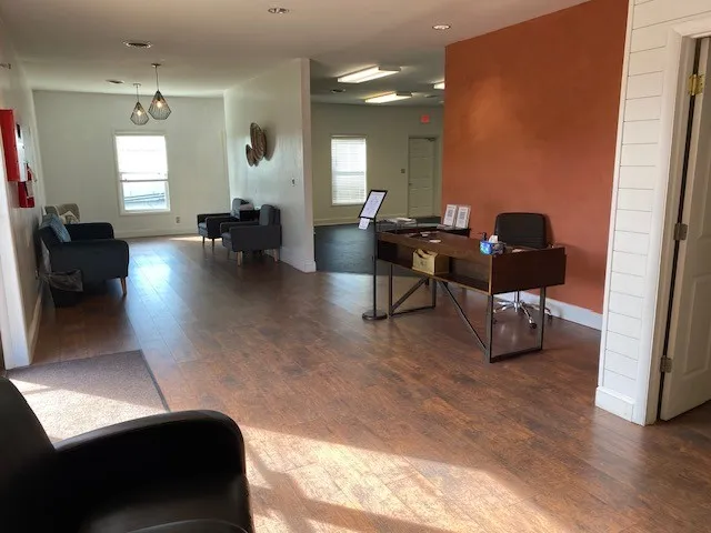 a living room with furniture and a large window