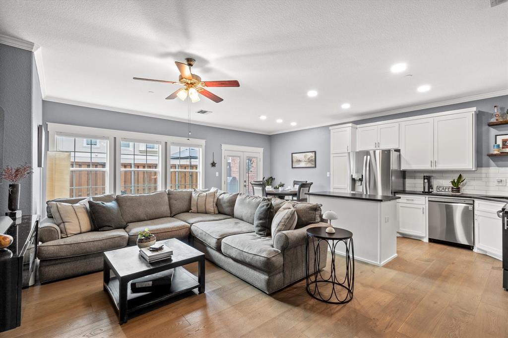 a living room with furniture kitchen and a chandelier